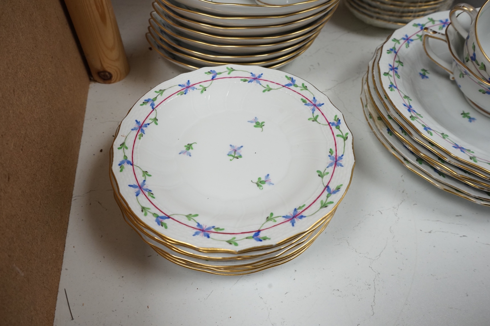 A Herend blue garland part tea set to include plates, twin handles cups and crescent dishes, largest 23cm in diameter
